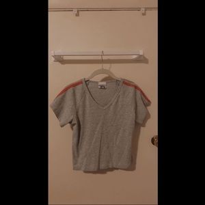 grey slightly cropped tshirt with orange shoulder stripes